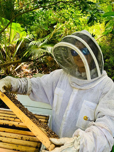 Francesca our Beekeeper inspecting a hive